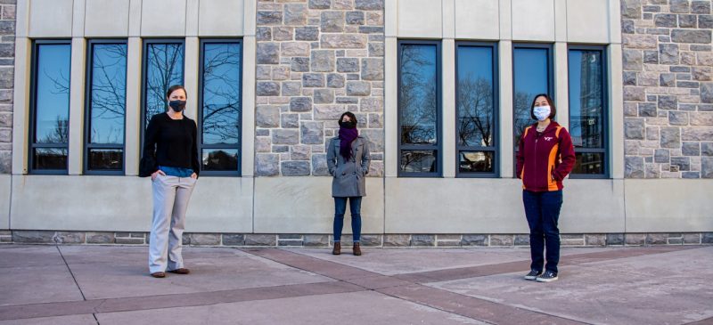 From left to right: Meryl Mims, Estrella Johnson, and Alma Robinson, all from the Virginia Tech College of Science. The women, dressed in winter garb and each wearing a mask per COVID safety protocols, are posing in front of the North End Center building.
