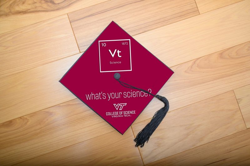 graduation cap on wood floor with "What's your science?" mortar board